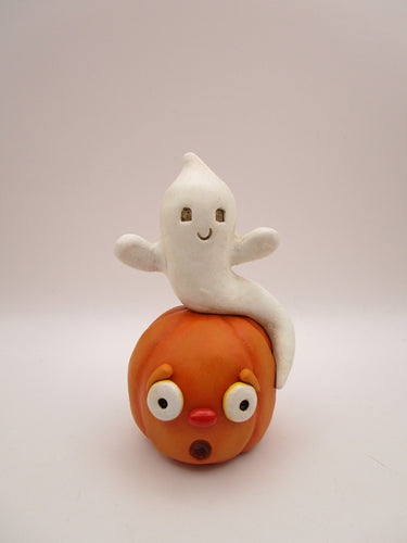 Halloween folk art cute ghost sitting on surprised pumpkin