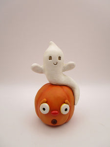 Halloween folk art cute ghost sitting on surprised pumpkin