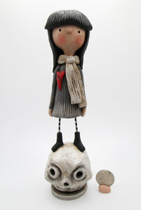 Sad dark gloomy girl standing on a skull Halloween ?