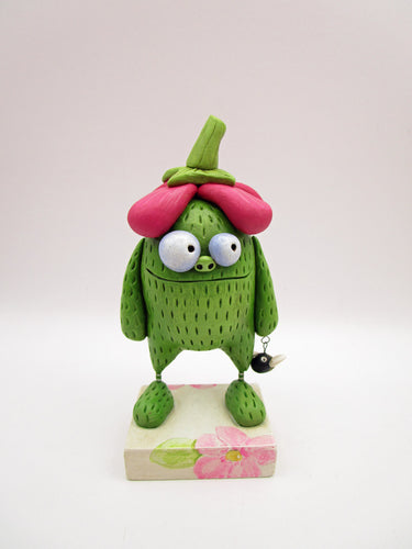 Spring folk art green monster with big flower top