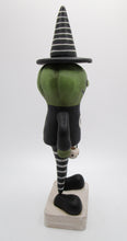 Halloween folk art green pumpkin man with witch hat and lots of stripes
