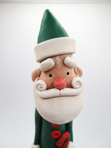 Christmas folk art Santa in green suit with candy cane