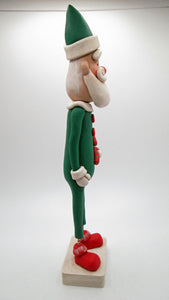 Christmas folk art Santa in green suit with candy cane