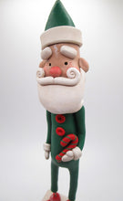 Christmas folk art Santa in green suit with candy cane