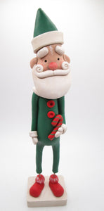 Christmas folk art Santa in green suit with candy cane