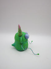 Monster folk art green twisty horned monster with bendable arms and legs