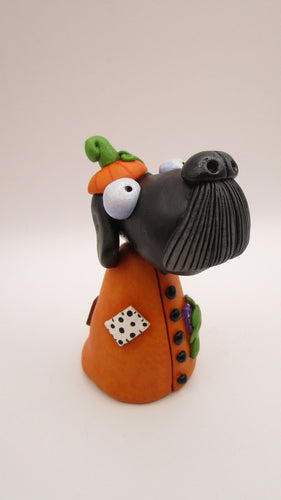 Halloween folk art Dog wearing a pumpkin 