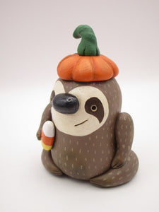 Halloween folk art sloth wearing pumpkin hat