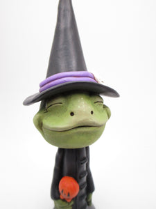 Halloween FROG dressed in witch costume with candy treat