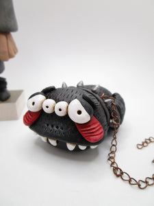 Halloween Igor Hunchback character with big pet spider on copper chain
