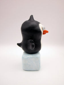 Christmas folk art penguin on block of "ice"