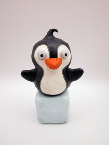 Christmas folk art penguin on block of "ice"