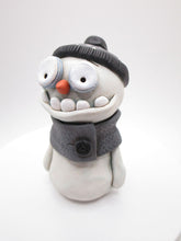 Christmas cute and creepy snowman wearing beanie and scarf