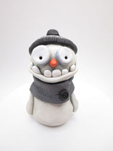 Christmas cute and creepy snowman wearing beanie and scarf