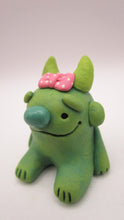 Monster character small green with pink bow