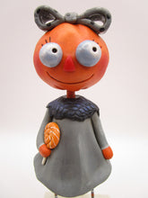Halloween folk art pumpkin girl holding Halloween lollipop