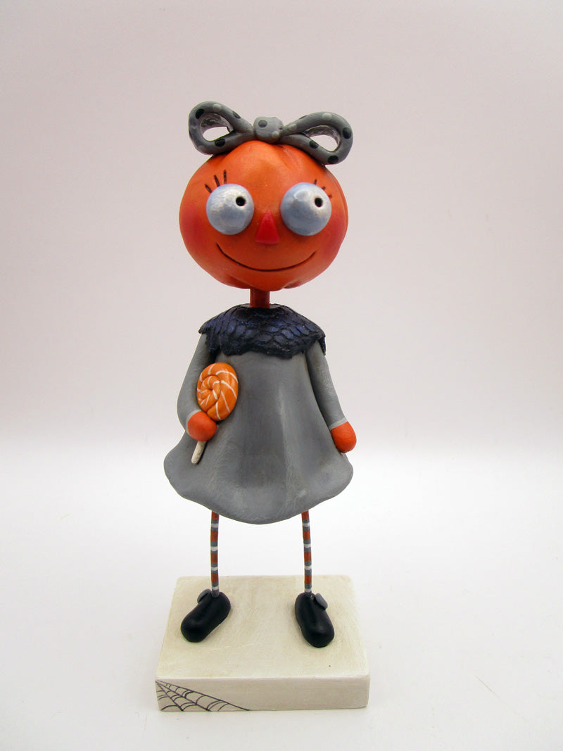 Halloween folk art pumpkin girl holding Halloween lollipop