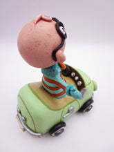Wacky character man with glasses in car
