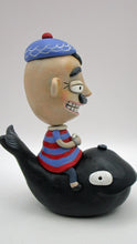 Man riding black whale with peeking conch great summer 4th of july folk art