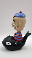 Man riding black whale with peeking conch great summer 4th of july folk art