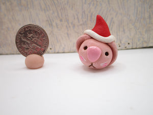 Mini pink bunny with Santa hat full body just over one inch tall