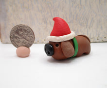 Mini brown dog with Santa hat just 1.25 tall and wide