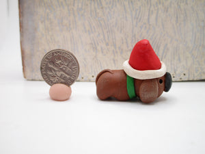 Mini brown dog with Santa hat just 1.25 tall and wide