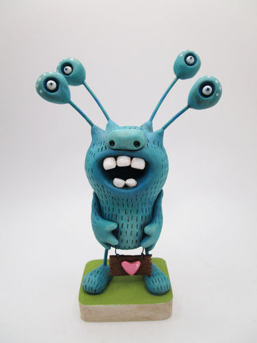 Monster folk art character blue with lots of extended eyeballs