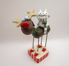 Christmas folk art reindeer with a yeti monster rider