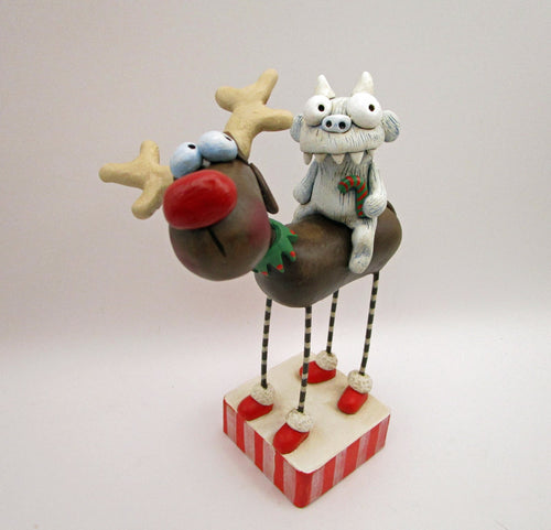 Christmas folk art reindeer with a yeti monster rider