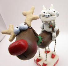 Christmas folk art reindeer with a yeti monster rider