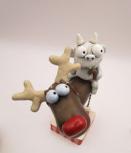 Christmas folk art reindeer with a yeti monster rider