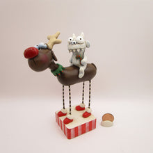 Christmas folk art reindeer with a yeti monster rider