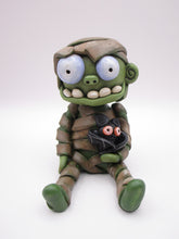 Halloween sitting Mummy man with BAT tugged in arm