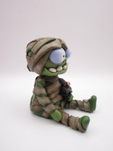 Halloween sitting Mummy man with BAT tugged in arm