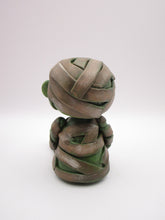 Halloween sitting Mummy man with BAT tugged in arm