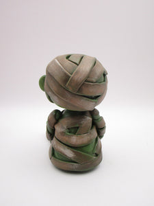 Halloween sitting Mummy man with BAT tugged in arm
