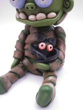 Halloween sitting Mummy man with BAT tugged in arm