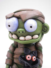 Halloween sitting Mummy man with BAT tugged in arm