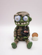 Halloween sitting Mummy man with BAT tugged in arm