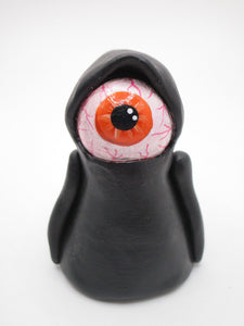 Halloween eyeball caped creature with orange bloodshot eye