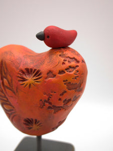 Valentine heart with bird on wood block with orange tones