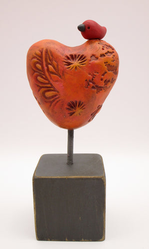 Valentine heart with bird on wood block with orange tones