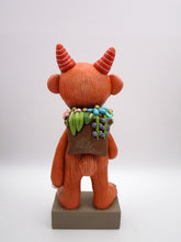Spring folk art large monster with sack of flowers on his back