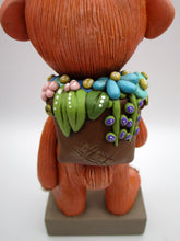 Spring folk art large monster with sack of flowers on his back