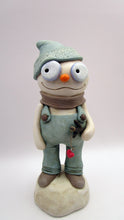 Christmas folk art snowman in muted teal overalls with heart stick