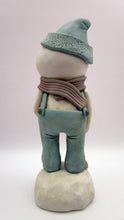 Christmas folk art snowman in muted teal overalls with heart stick