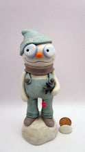 Christmas folk art snowman in muted teal overalls with heart stick