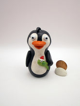 Christmas folk art penguin with a fish in hand
