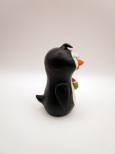 Christmas folk art penguin with a fish in hand